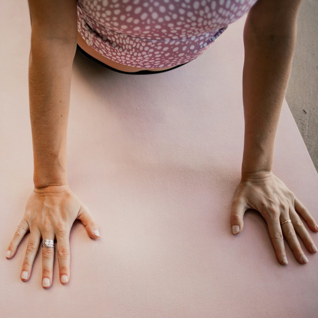 yoga lady claire yoga Elderly woman seated in a yoga pose, smiling, with a dog resting nearby.
